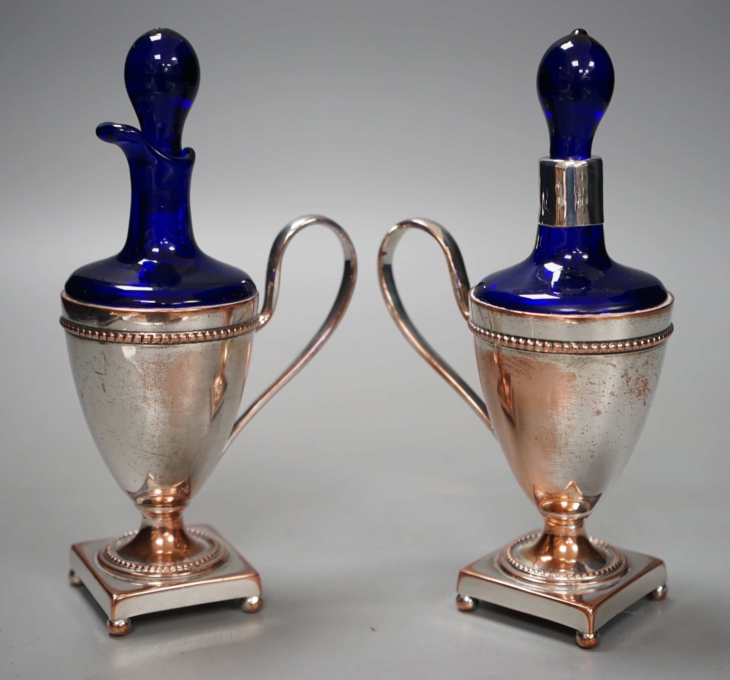 A pair of plate mounted blue glass scents, 16.5cm tall